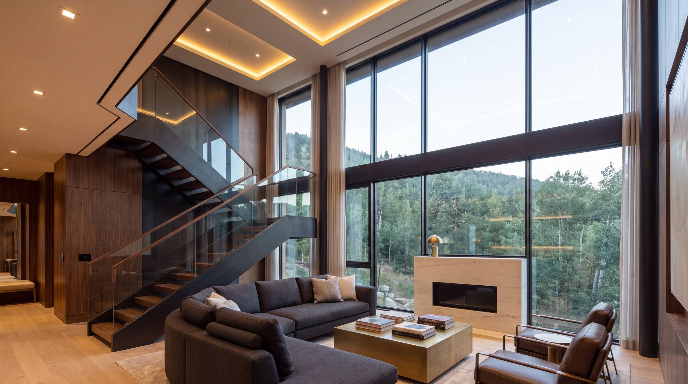Double-height great room with a wall of glass and a sculptural staircase