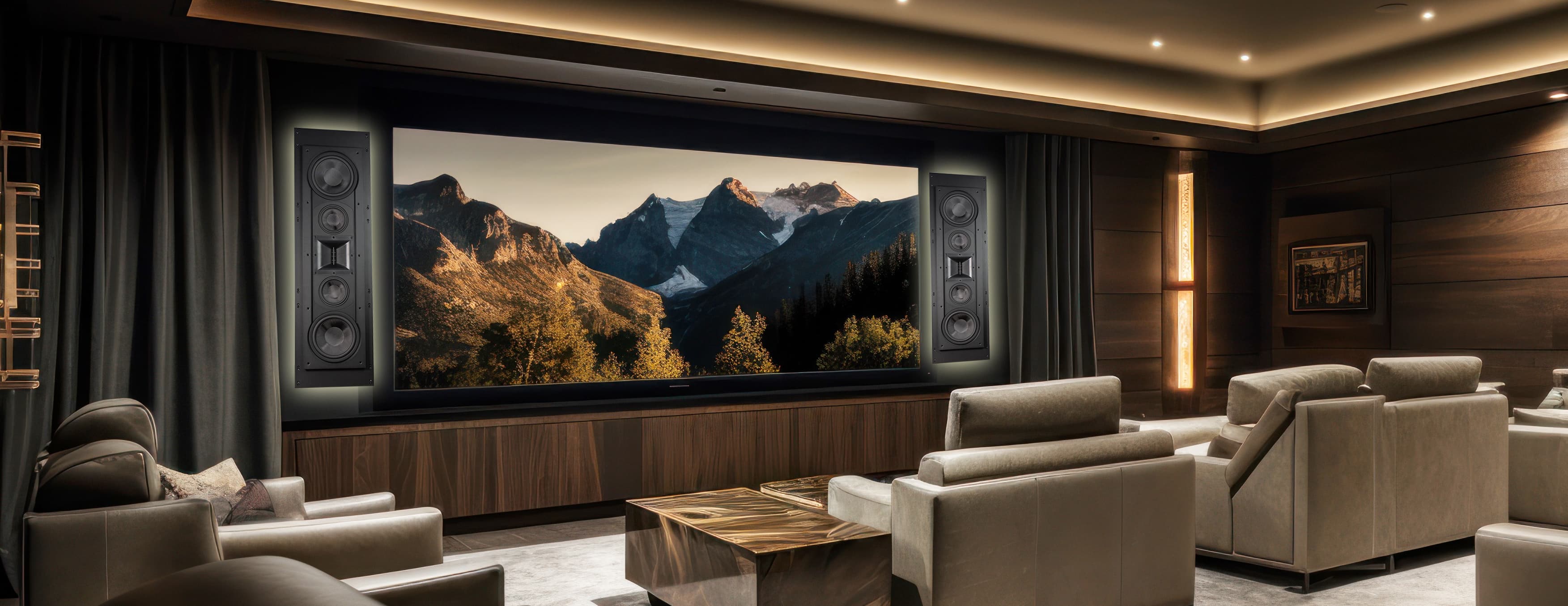 Private home cinema with a wide screen framed by on-wall loudspeakers, walnut millwork, and layered leather seating